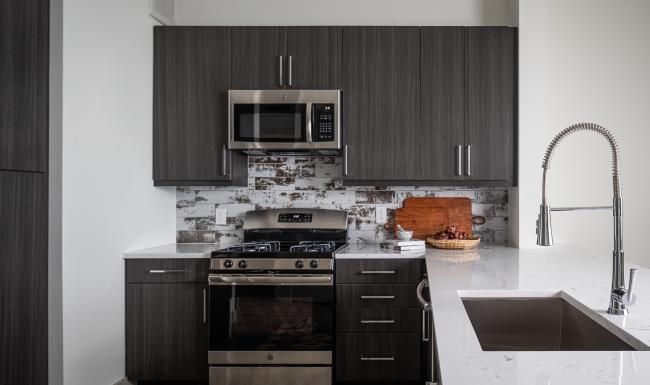 a kitchen with black cabinets