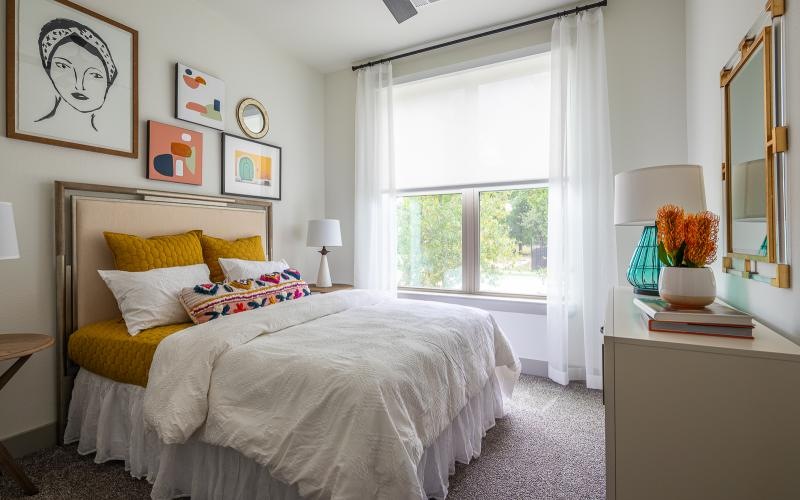 a bedroom with a bed and a dresser