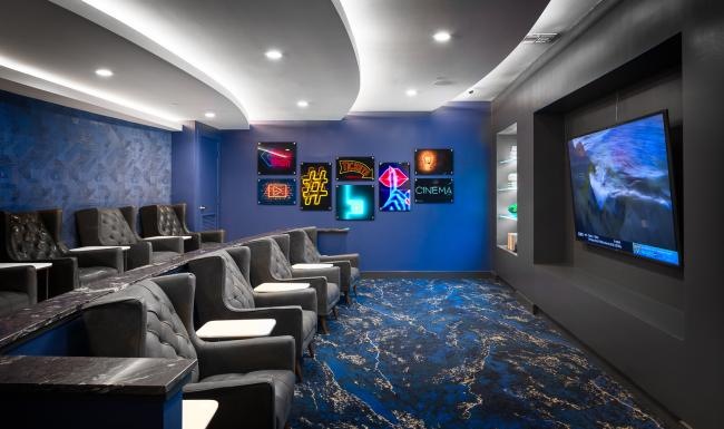 a movie theater with a large screen and chairs
